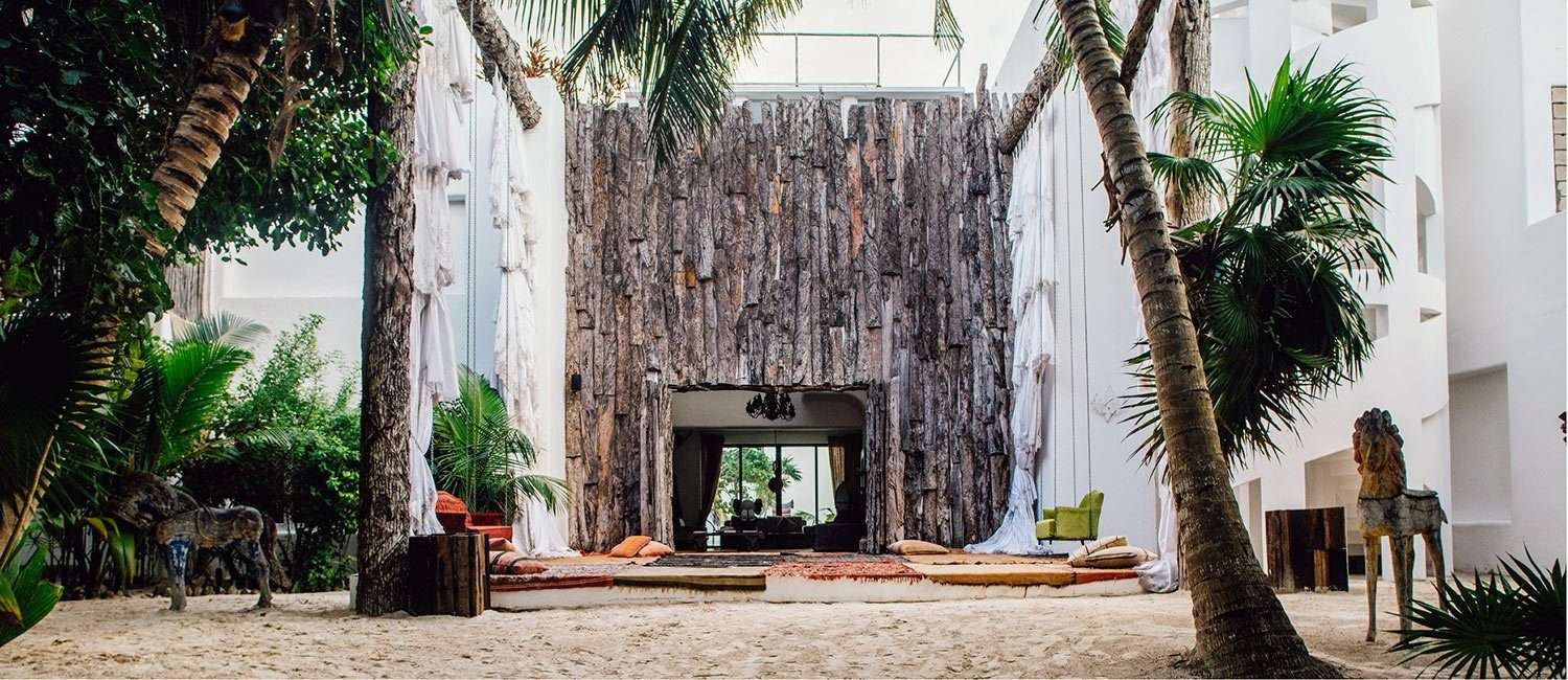 Beachfront house with hung artworks in an open corridor