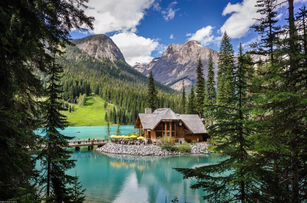 Timber lodge buildings on the shore of a frozen mountain lake